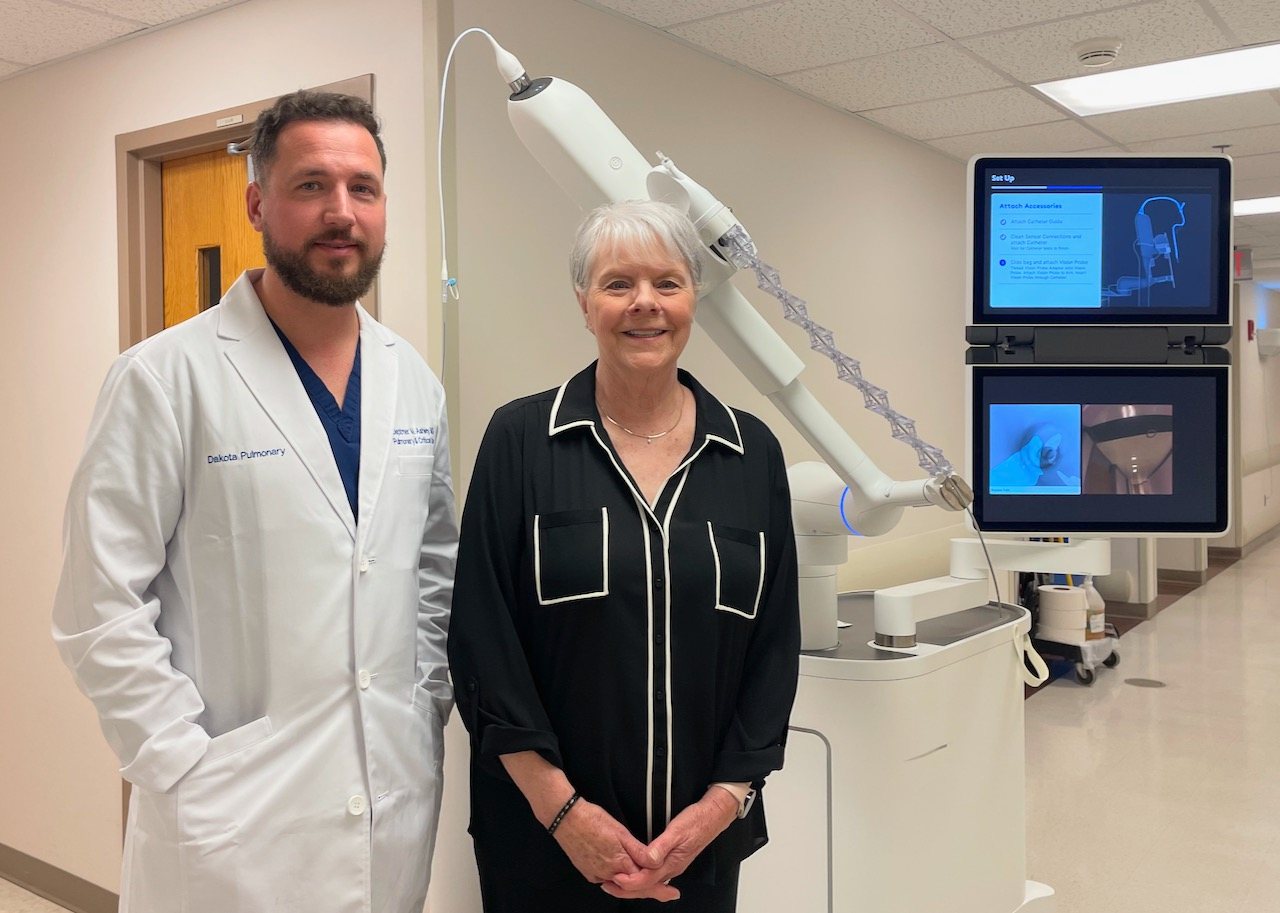 Dr. Deptmer Ashley beside the Ion robotic bronchoscopy system at Dakota Pulmonary
